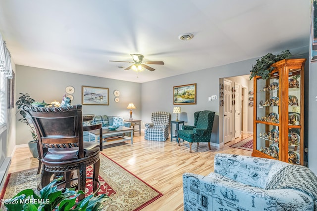 living room with ceiling fan and hardwood / wood-style floors