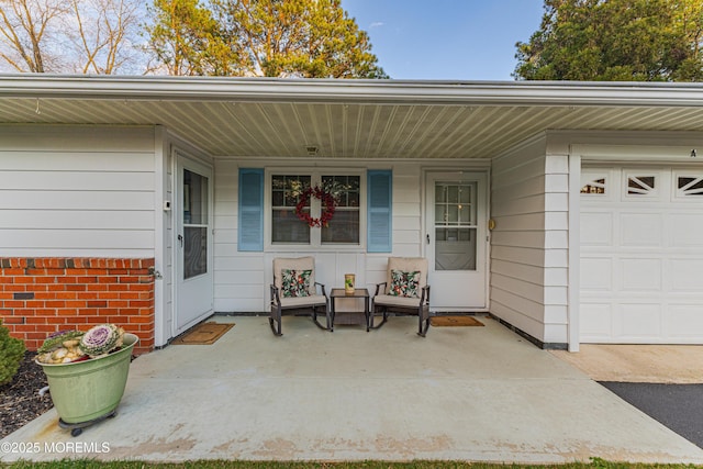 property entrance featuring a porch and a garage