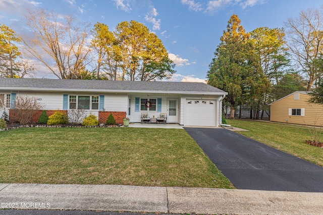 single story home featuring a porch, a garage, and a front yard