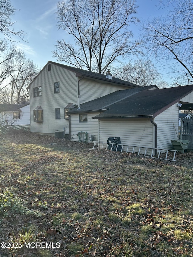 back of house featuring central air condition unit