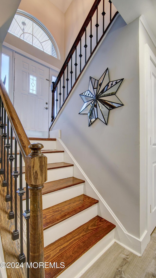 stairs featuring hardwood / wood-style flooring