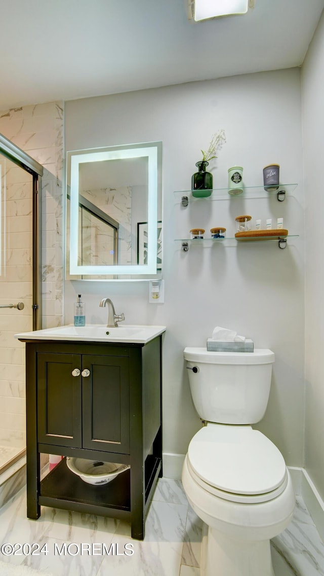 bathroom with vanity, toilet, and walk in shower