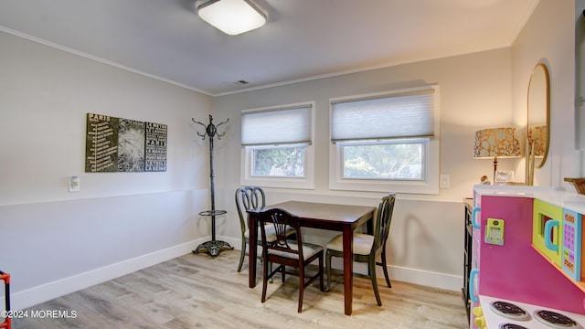 dining room with hardwood / wood-style floors and ornamental molding