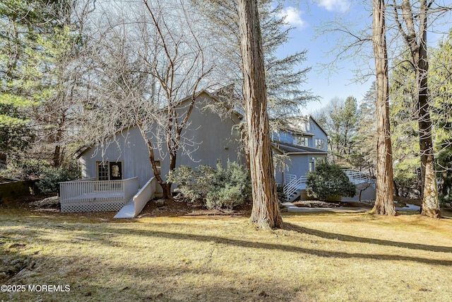 view of home's exterior featuring a yard and a deck