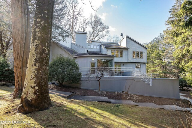 exterior space featuring a wooden deck and a yard