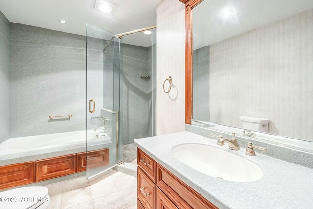 bathroom featuring tile patterned flooring, vanity, toilet, and a shower with shower door