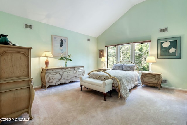 bedroom featuring light carpet and high vaulted ceiling