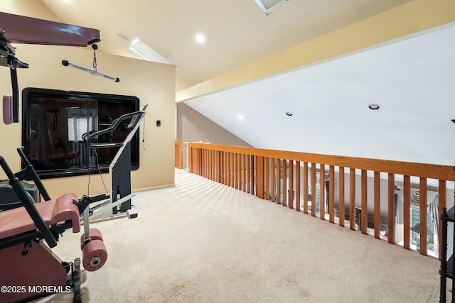 exercise room featuring carpet floors and vaulted ceiling