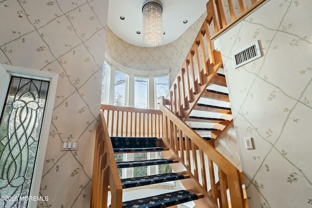 stairway with an inviting chandelier