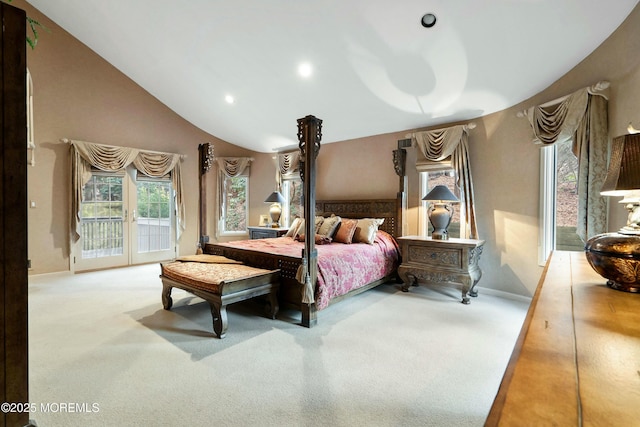 carpeted bedroom with access to exterior, french doors, and vaulted ceiling