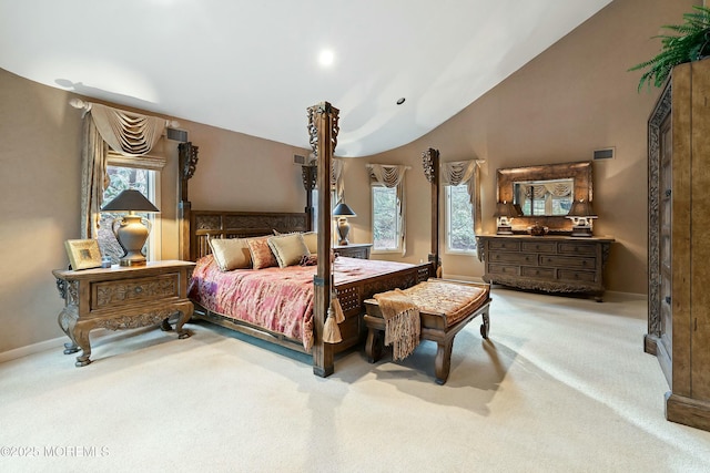 carpeted bedroom with lofted ceiling