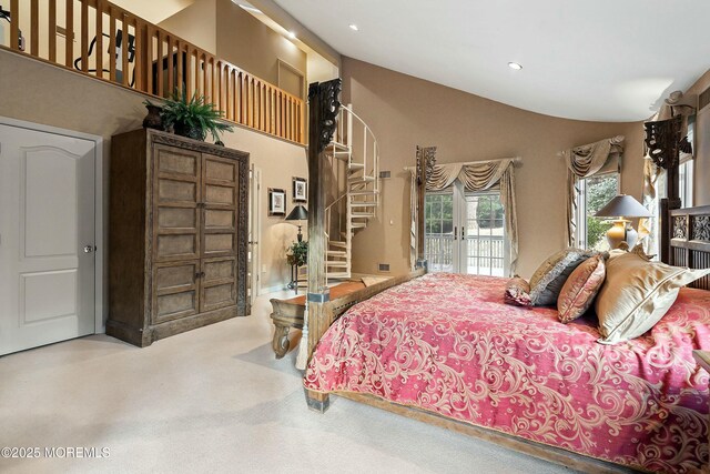 bedroom with access to exterior and high vaulted ceiling