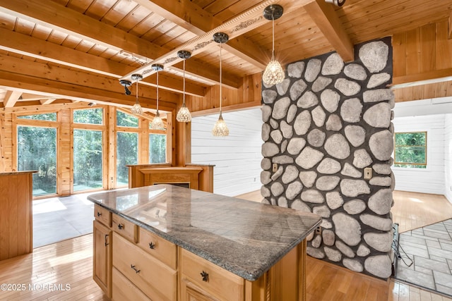 kitchen with hanging light fixtures, light wood-type flooring, wood ceiling, and wood walls