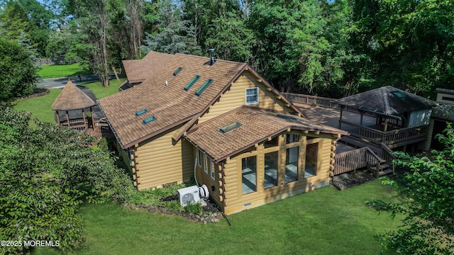 rear view of house featuring a gazebo, a deck, and a yard