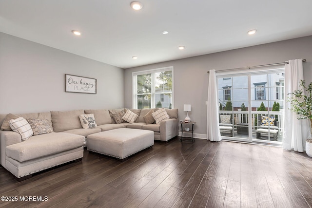 living area with baseboards, dark wood finished floors, and recessed lighting