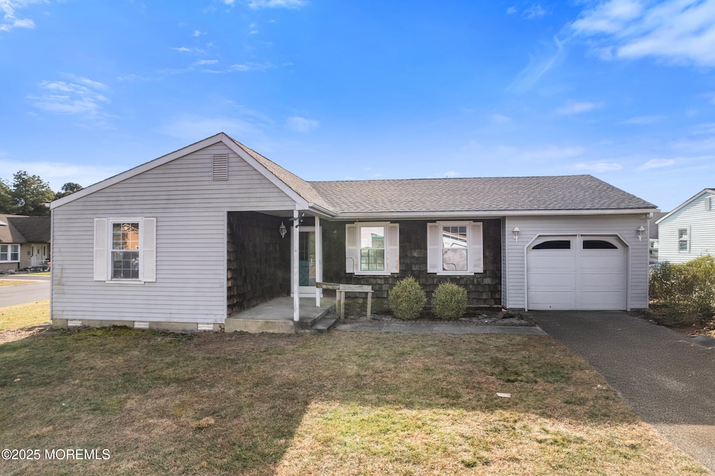 single story home with a front lawn and a garage