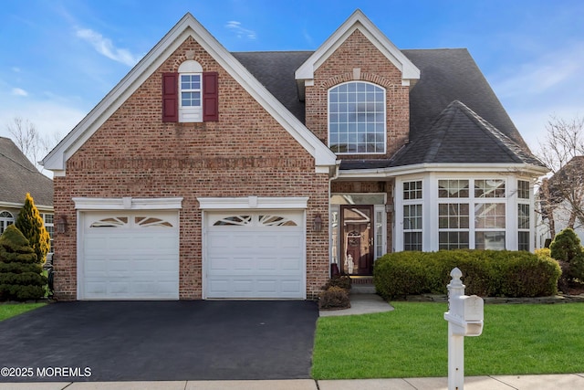 front of property with a front yard and a garage