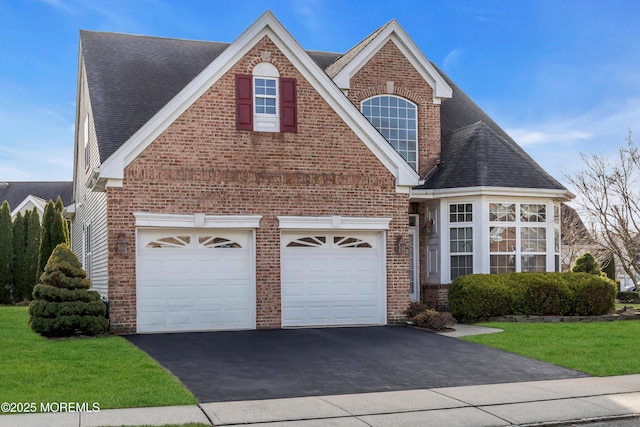 view of front of home featuring a garage and a front lawn