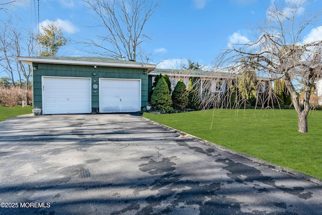 ranch-style home with a front yard and a garage