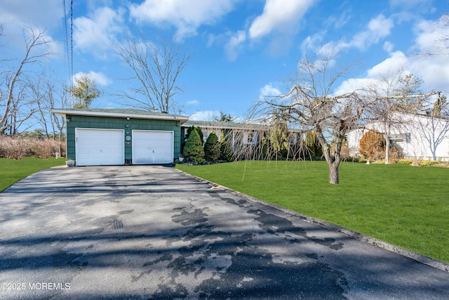 ranch-style house featuring a front lawn and a garage