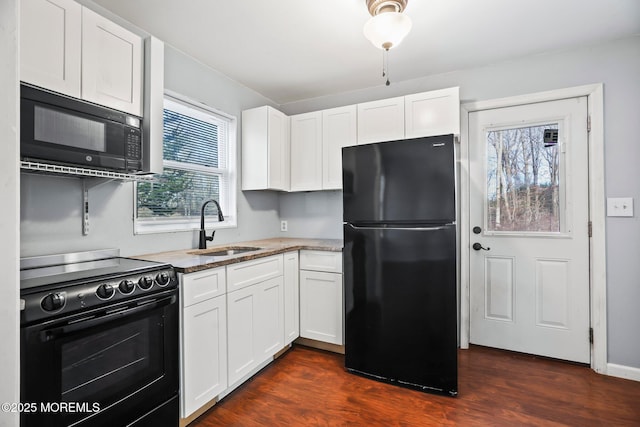 kitchen with black appliances, dark hardwood / wood-style flooring, white cabinetry, and sink