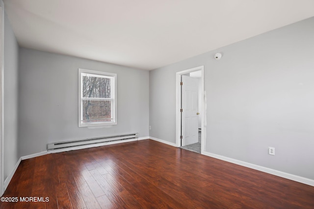 spare room with hardwood / wood-style flooring and a baseboard heating unit