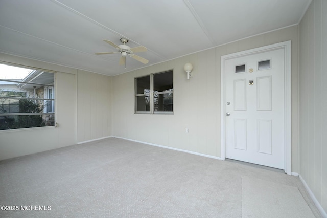 unfurnished sunroom featuring ceiling fan