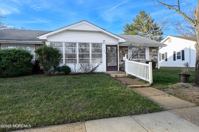 view of front of home with a front lawn and a sunroom