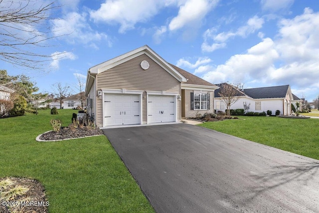 single story home featuring a garage and a front lawn