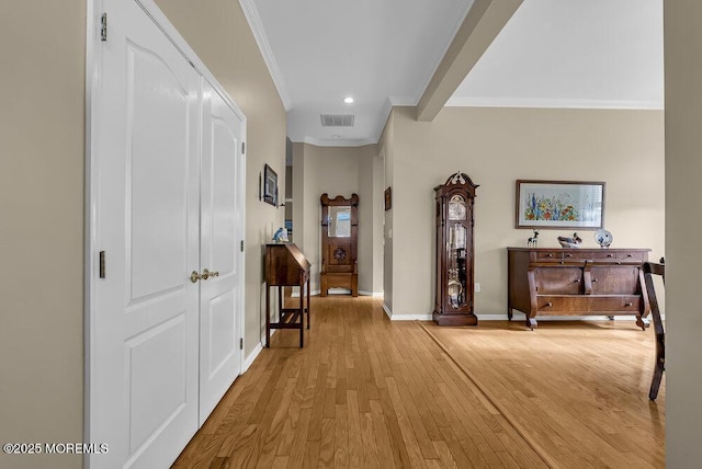 hall featuring ornamental molding and light hardwood / wood-style flooring