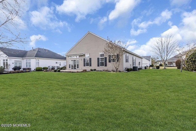 back of house featuring a lawn and cooling unit