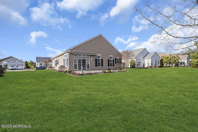 back of house featuring a lawn