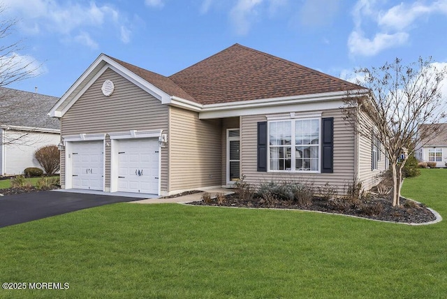 view of front of property with a front yard and a garage