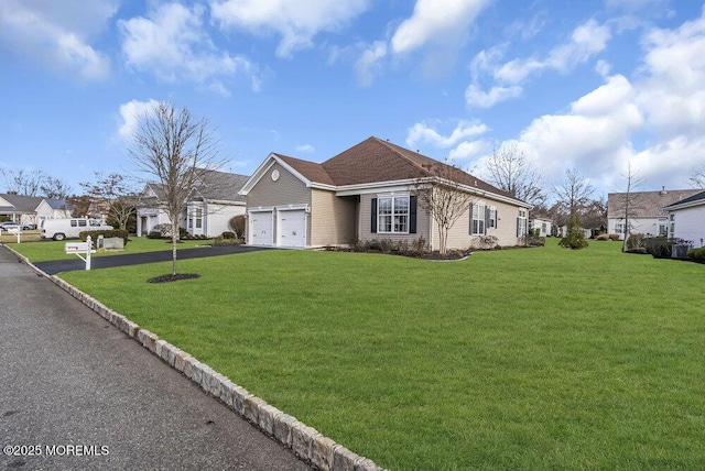 view of front of house featuring a garage and a front lawn