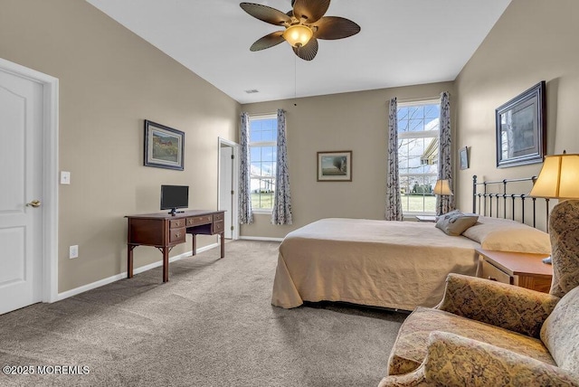 carpeted bedroom with multiple windows, ceiling fan, and lofted ceiling