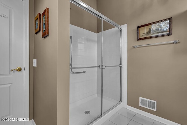 bathroom featuring tile patterned floors and a shower with door