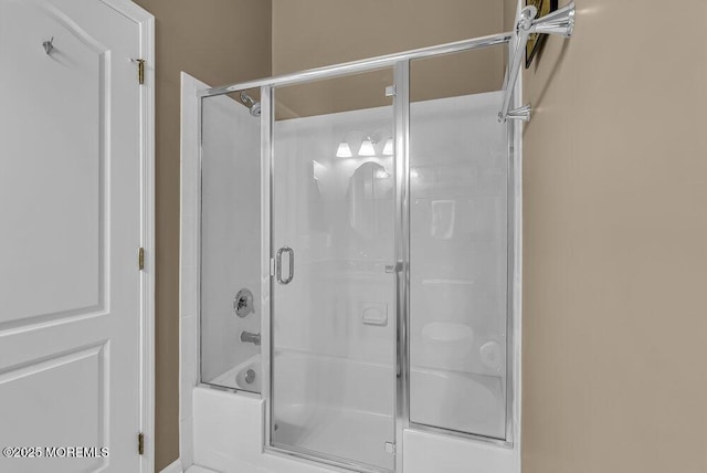 bathroom featuring bath / shower combo with glass door