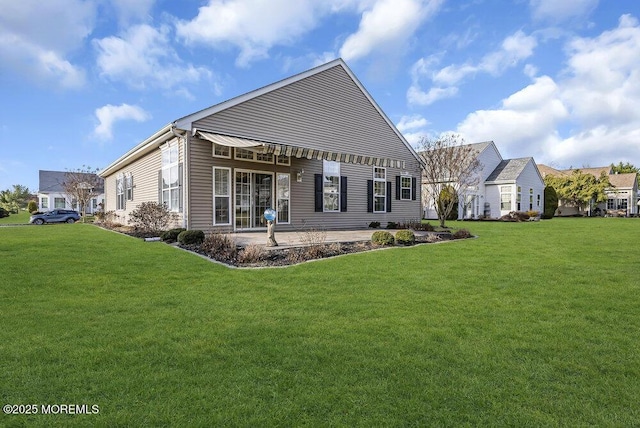 rear view of property with a lawn