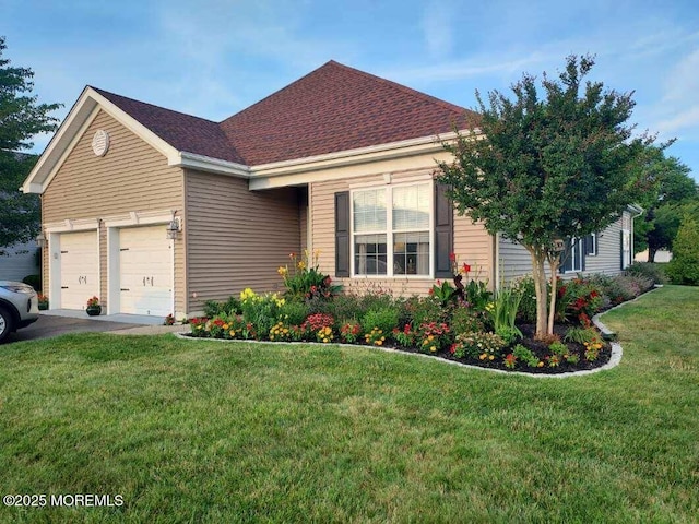 view of front of house with a front yard and a garage