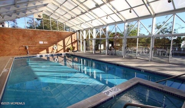 view of pool featuring a lanai, a patio area, and an indoor hot tub