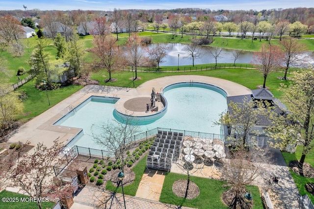 view of pool featuring a water view and a yard