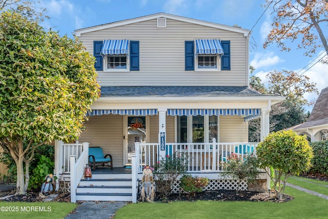 view of front facade with a porch and a front lawn