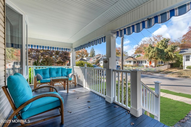 wooden deck featuring an outdoor hangout area and a porch