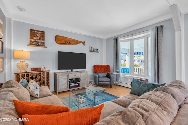 living room featuring light hardwood / wood-style floors, ornamental molding, and a baseboard radiator