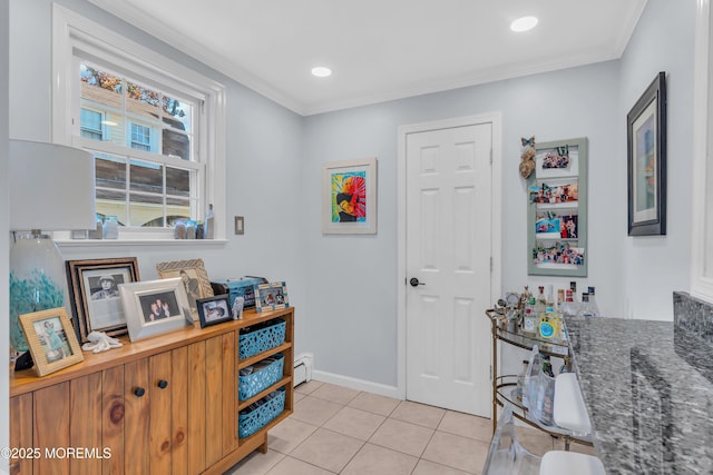 interior space with ornamental molding and a baseboard heating unit