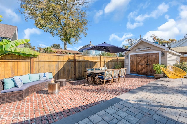 view of patio featuring outdoor lounge area and an outbuilding