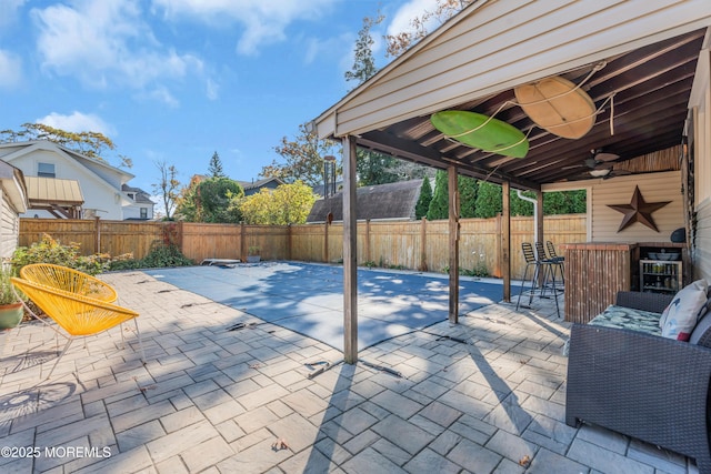 view of patio featuring exterior bar and ceiling fan