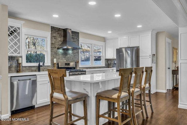 kitchen featuring backsplash, wall chimney exhaust hood, stainless steel appliances, white cabinets, and dark hardwood / wood-style floors