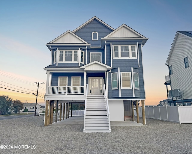 coastal home featuring a porch and a carport