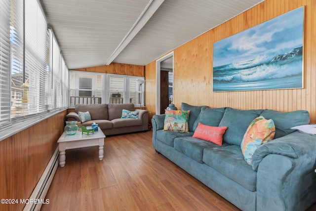 living room with hardwood / wood-style floors, wooden walls, vaulted ceiling, and a baseboard heating unit